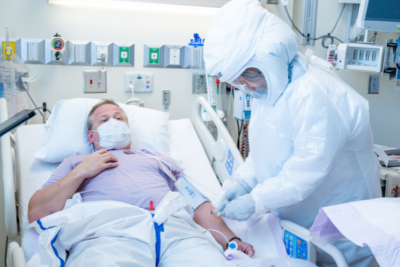 Person in PPE treating a patient