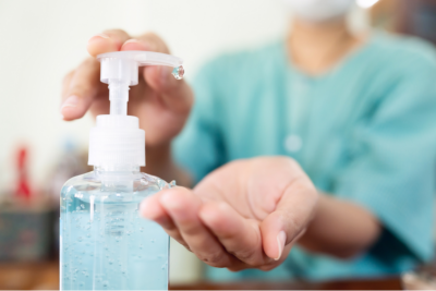 Close up of a person using hand sanitizer